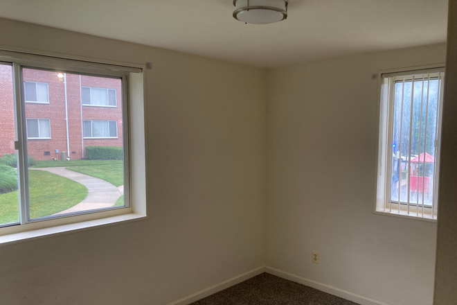 Wide angle of the bedroom, two bright windows with views of the greenery - Graduate Hills Apartments, Extra Bedroom, Super Close to Campus