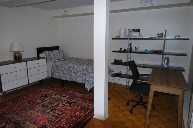 Bedroom view of bed , desk and shelving unit against wall - 1 Bedroom Baldwin Village  Unit all utilities Included