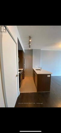 Entry way and kitchen with pantry door - Luxury 1BR Condo – Walk to Subway, U of T, Scotiabank Arena (Optional Furnished for + $350 / month)