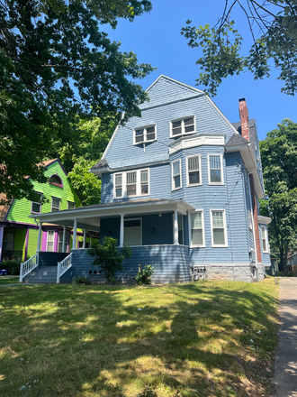 Front of the two-family home. This apartment is on the second and third floor. - Furnished 5 Bed 2 Bath Room Rental Home (Utilities Included)