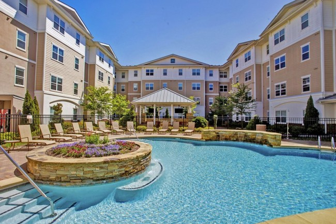 Outdoor pool and apartment - Campus Crossings Briarcliff Apartments