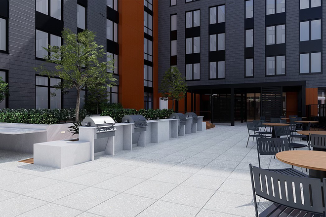 Outside common space patio with grills, pool table, shuffle board and common space - Union on Knox Apartments