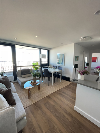 Living room with dining table - Summer Sublet – Furnished 1BR in Soldiers Field Park (Luxury Building, Steps from HBS) Apartments