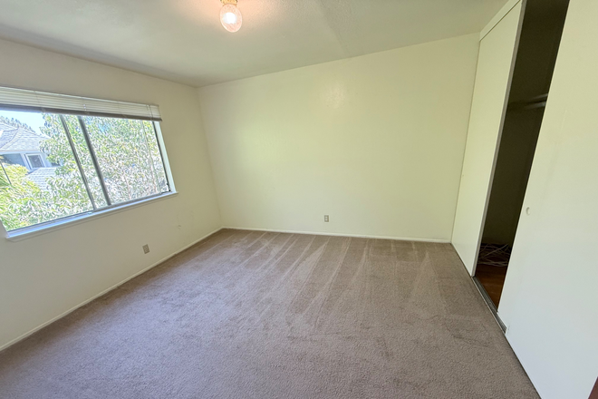 Bright bedroom with natural light and space for a bed, desk, and other furnishings. - 2BR Apartment Near UC Berkeley & Ashby BART