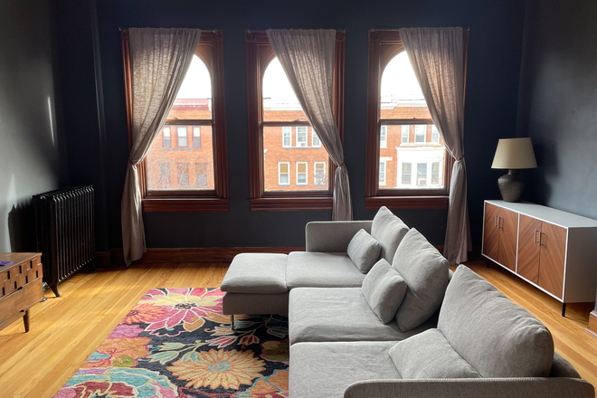 Living room photo 2: Large bright windows with large sectional - Furnished apartment in historic row home, including utilities+internet+cleaning (1 b