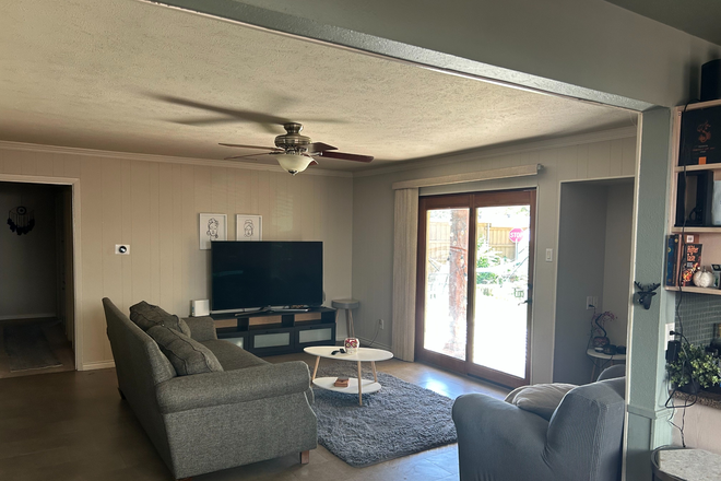 Fully Furnished Living Room with a samsung smart TV and surround sound speakers. - Spacious 3 Bedroom 2 Bathroom Home Steps Away from Campus (Ideal for Students)
