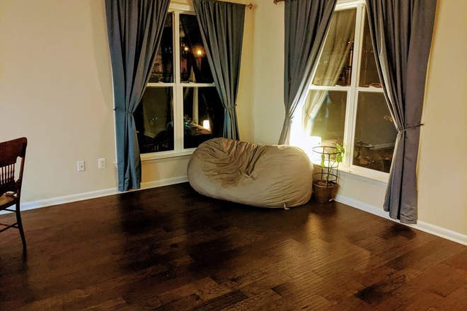 Living Room - $989 Room + private bathroom in a luxury townhouse. Amazing rooftop deck, one block to UMD shuttle.