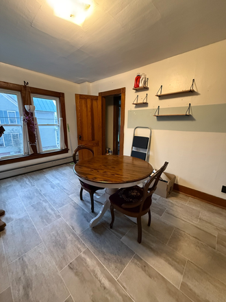 Front door view of kitchen and windows - bathroom is to the left and down two steps. - *Furnished* Studio Apartment!