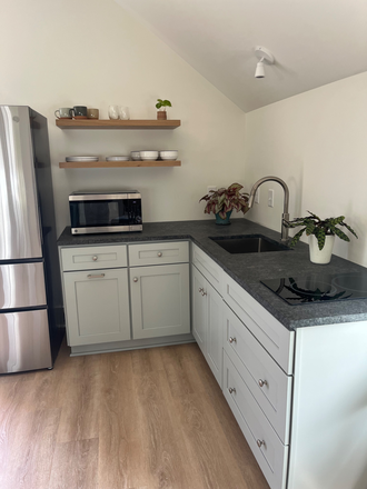 Kitchen-micowave/air fryer/convection and stovetop - Old Village guest cottage available for 30 day rental House