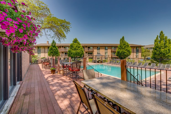 Outside view from clubhouse deck of pool area and building exterior. - Apartment Close to Campus, bus stop to and from campus