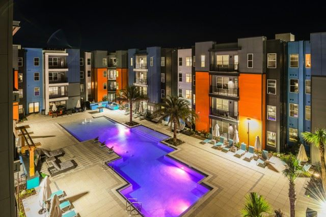 Pool/Courtyard Area at Nighttime - Lark Gainesville Apartments