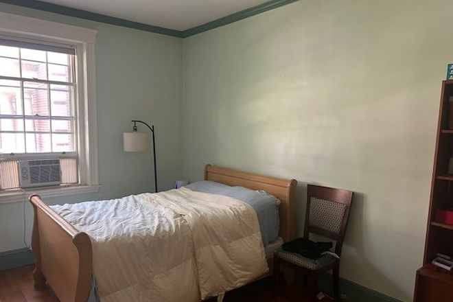 Primary bedroom (also has desk, chair, 2 closets, bookcase)s, bookcase) - Primary Bedroom in Coolidge Corner condo with beautiful courtyard
