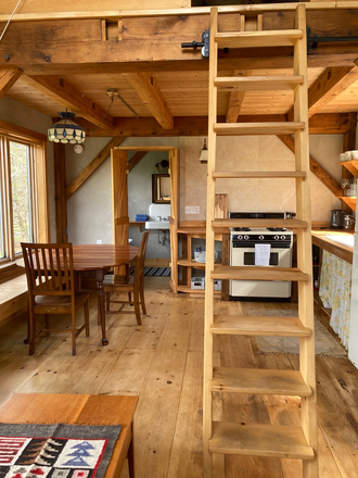 View from entry, bathroom at rear with toilet tub and shower - Longest Acres Farm Cabin