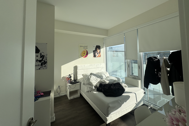 Bedroom, bathroom inside on left. - Master bedroom in 2 bed 2 bath unit