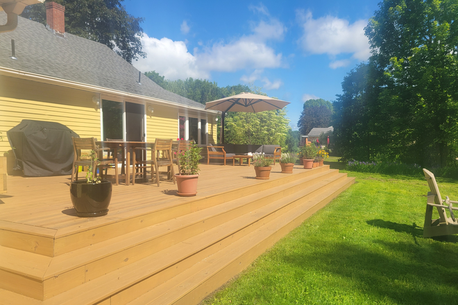 Deck with fire pit and sliding door leading to dining room - Quiet Conveniently Located Home