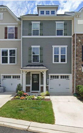 Front of house - 4 bd, 3.5 bath waterfront 2017 townhome. Great for relaxing/hosting. Hot tub onsite. Gated backyard.
