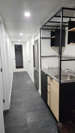 Kitchenette directly across the door to the Bed/living area on the left - Newly-renovated Basement studio with full-sized windows in SFH; 1 mile to CUA House