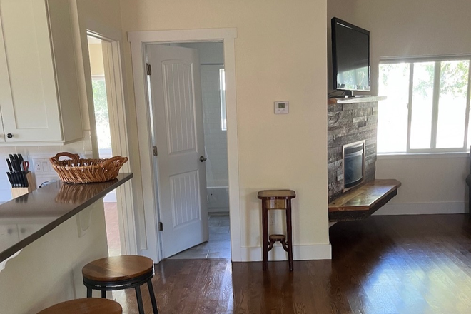 living room with electric fire place and barstools - House for rent on horse facility. East Boulder. Can trade ranch chores/rent