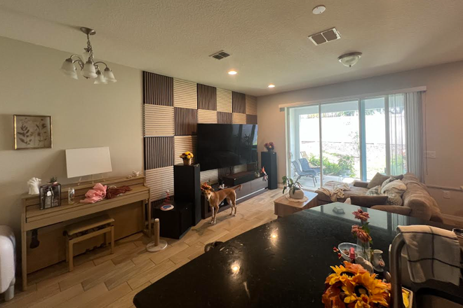 Home Theater I setup. Shows living room, patio, and kitchen island - Townhouse 10 mins from UCF- very quiet and safe neighborhood