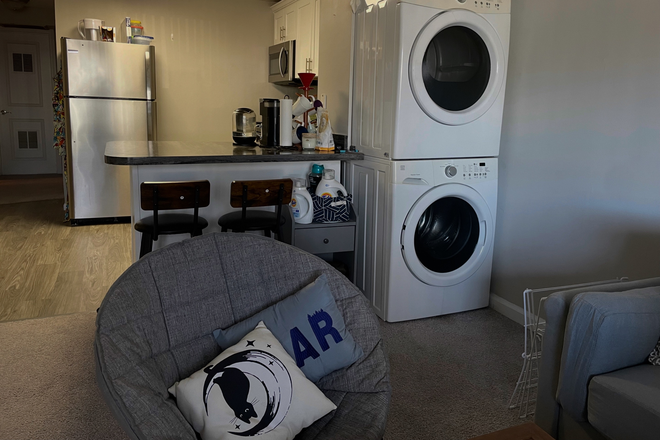 Shared living space. Kitchen, washer & dryer, and living room. - Alpine Commons Apartments