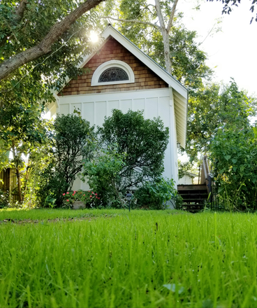 View across a lush lawn - Gorgeous, furnished tiny house for one in downtown garden oasis. Flex. lease/incl. all utilities