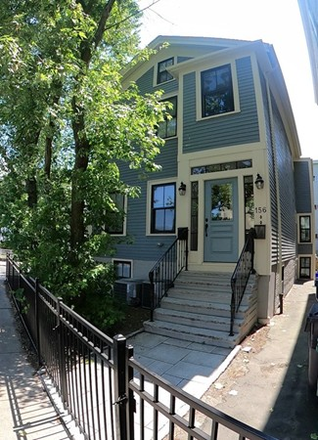 Mature trees and a black fence surround the front and side yards. - Townhouse,5beds 4 baths, 2Parking, Inman, Central, walk to MIT, yard