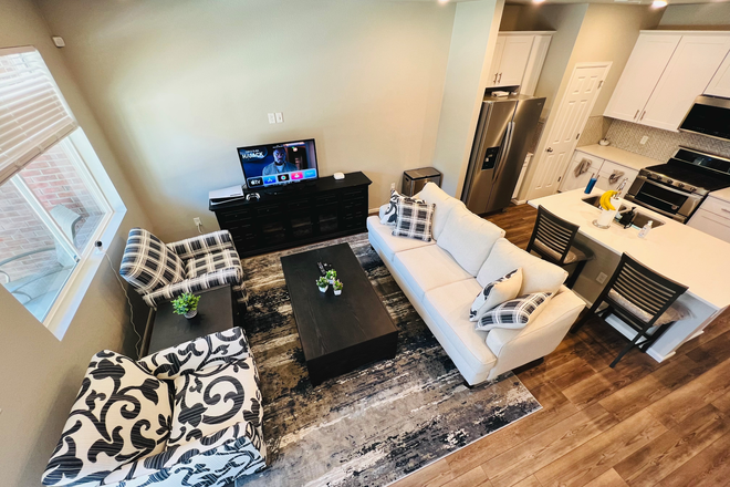 Living Room - $999/month. Furnished room in a furnished town home. All utitlities incuded. Parking included.