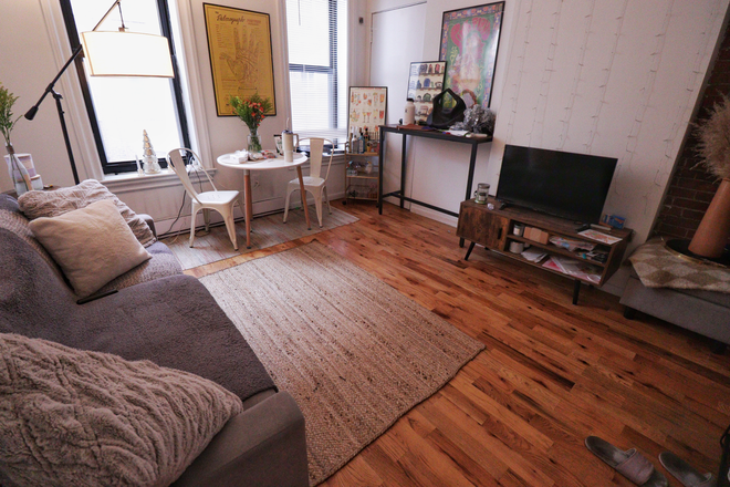 Living Room - Bright & Stylish 1-Bedroom in the Heart of Bay Village Apartments