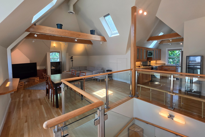 Living room and kitchen - Modern 2 Bedroom with Cathedral Ceilings and in-unit Laundry. Harvard Sq. Condo