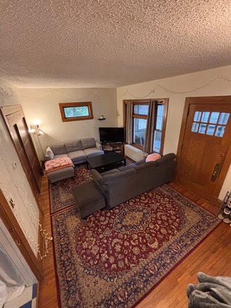 Excellent common/living area featuring hardwood floor and complimentary area rugs. - Beautiful Victorian home directly across from campus