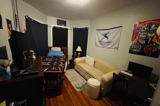 Bedroom for rent (black curtains covering windows) - Mission Hill Summer Sublet – Furnished Room, Washer/Dryer, Central Air, Backyard + Balcony