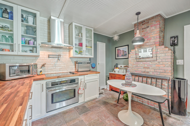 newly renovated kitchen with exposed brick fireplace - Terrace Cottage Rental