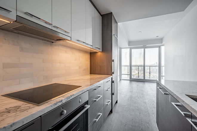 Common Area + Kitchen - Looking for Female Roommate for Furnished Private Bed + Bath in Modern Condo