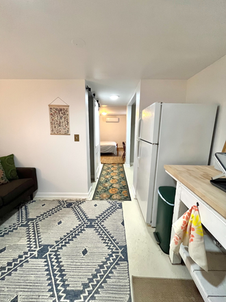 View from living area toward bedroom - Charming Furnished Basement Apt in Riverdale Park