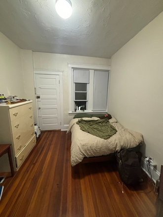 Bedroom from the front. Door leading to deck inside bedroom has a deadbolt. - Bedroom available in Apartment off of Allston St stop