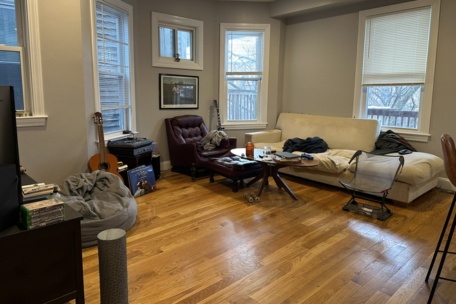Living Room - 3BR/1BA: Central Air + In-Unit Laundry + Private Deck Apartments
