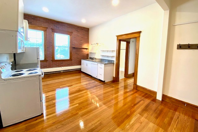 Kitchen and living area - Avail 7/1/26 Four Bedroom, two full bathrooms, hardwood floors above Bueno Y Sano