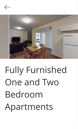 Living Room with couch, tv, and kitchen fully furnished - 1 Bedroom Apartment in Schoolhouse Lofts; Walking distance from campus