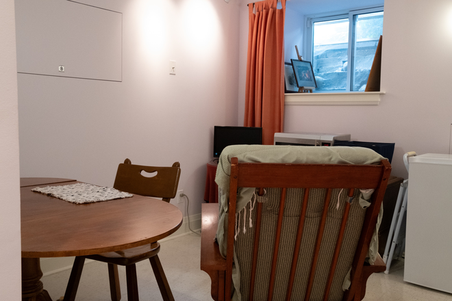Dining table, chair, glider rocker, window facing east - Lovely private, quiet furnished all-inclusive suite with private laundry in historic Seaton Village
