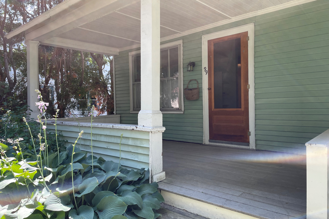 Front porch great for watching the world go by. - Charming 3 bedroom apartment in 5 Sister's neighborhood