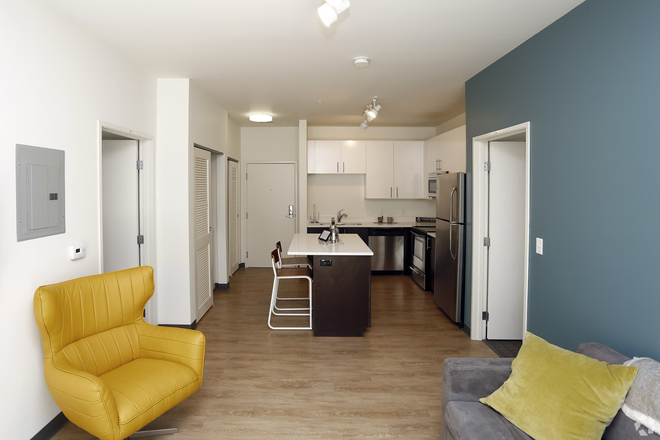 Living room with view towards kitchen (sample) - 1 bedroom w/ attached bedroom at Fuse Apartments (across from Armstrong Hall of Engineering)