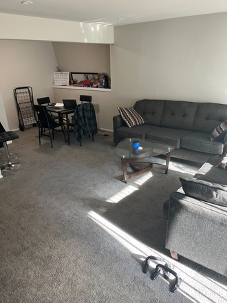 This is the living room. 2 couches, a glass table, and a dining table on the side. - The Hills at KenilWorth