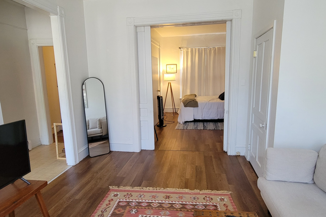 living room to bedroom view - Walk to UVM. 1 bed townhouse. 9ft ceilings pocket doors. Huge with heat & parking included