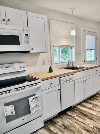 Bright kitchen with full-size refrigerator and stove for your home-cooked meals. - Ready NOW! Newer 2-Bedroom House. Washer/Dryer Included. 7-minute drive to UTK.