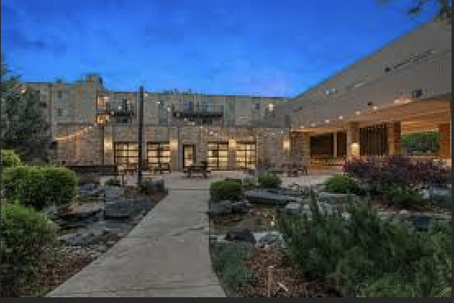 Outdoor Area with grill and patio tables - The Mountainaire Apartments