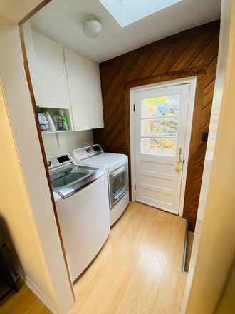 Shared Laundry - back door leads to garden - Furnished 2-room apartment for rent connected to family house.