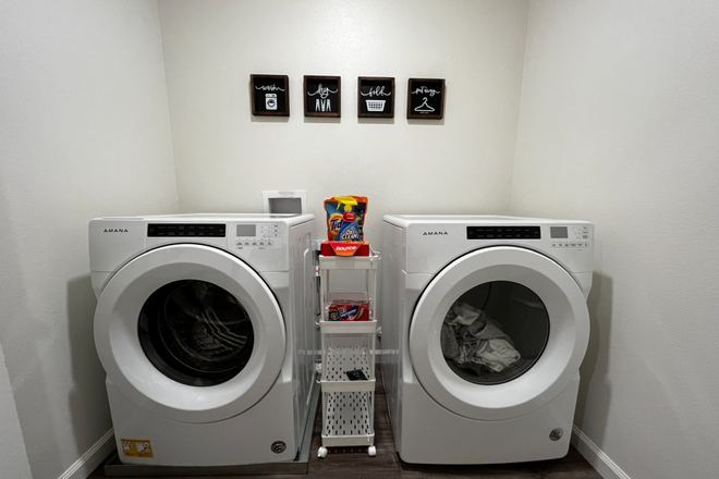 Laundry Room w/Ironing Board - Fully Furnished Rooms, All Utilities + Other Amenities Included in Monthly Rent House