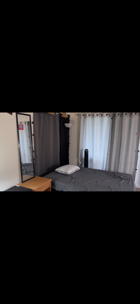 Twin XL bed with pillow side table, side lamp, fan and dresser table with ample storage - Brandywine Apartments