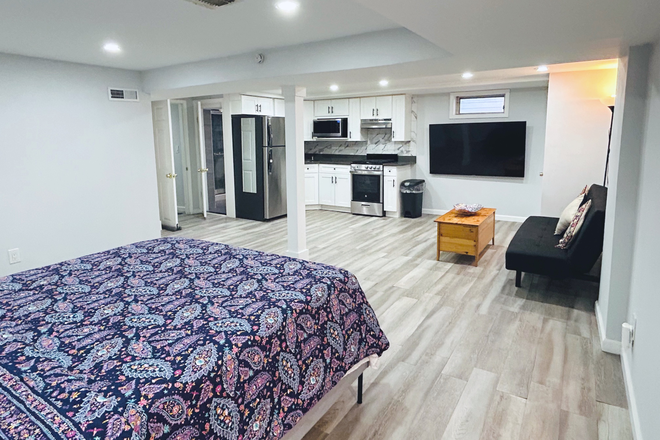 Bright, open-concept studio apartment with bathroom, kitchen, and sitting area - Furnished Studio Apartment close to campus
