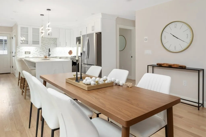 Seamless flow from the kitchen to the dining area perfect for entertaining friends or family. - Steps to Tufts: Sunny 4-Bed at 157 Boston Ave Condo